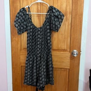 Black romper with a cute green and white pattern.